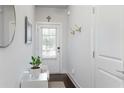 Bright entryway featuring white walls, coat hooks, and a decorative mirror at , Atlanta, GA 30316