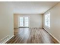 Bright living area featuring wood-look floors, a double glass door to the outside, and a large window at 270 Hunt Ridge Dr, Stockbridge, GA 30281