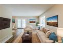 Cozy living room with beige furniture, neutral walls, hardwood floors, and plenty of natural light at 270 Hunt Ridge Dr, Stockbridge, GA 30281