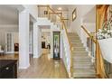 Inviting foyer with hardwood floors and a staircase, creating an elegant and open entrance to the home at 5100 Sunset Maple Trl, Lilburn, GA 30047