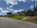 Lovely neighborhood, this house boasts a well-manicured lawn and stylish gray exterior at 6165 Namon Wallace Dr, Cumming, GA 30028