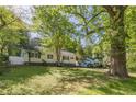 Charming one-story home with white siding, black shutters, and mature landscaping at 1050 N Carter Rd, Decatur, GA 30030