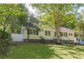 Charming one-story home with white siding, black shutters, and mature landscaping at 1050 N Carter Rd, Decatur, GA 30030