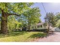 Charming one-story home with white siding, black shutters, and mature landscaping at 1050 N Carter Rd, Decatur, GA 30030