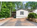 Inviting home featuring a covered porch and landscaped front yard at 164 Chickasaw Ln, Austell, GA 30168