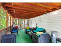 Cozy screened porch with seating area, perfect for outdoor enjoyment at 164 Chickasaw Ln, Austell, GA 30168