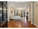Spacious living room featuring hardwood floors, a fireplace, and ample natural light at 225 Wexford Overlook Dr, Roswell, GA 30075