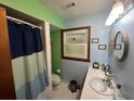 Cozy bathroom featuring a vanity with a white sink, window, and a tub and shower at 2932 Highway 20 Se, Conyers, GA 30013