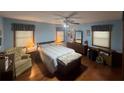 Serene bedroom with a ceiling fan and a comfortable bed, accented by a cozy sitting chair at 2932 Highway 20 Se, Conyers, GA 30013