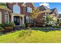 Beautiful front of the house with a well-kept lawn, walkway, and blooming flowers at 3855 Greenside Ct, Dacula, GA 30019