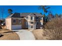Charming home with a large front yard and driveway leading up to the attached garage at 4197 Trotters Way Dr, Snellville, GA 30039
