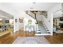 Elegant foyer with hardwood floors and a staircase adorned with decorative pictures at 5452 Tally Green Dr, Marietta, GA 30068