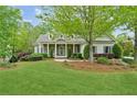Charming single-Gathering home with well-manicured lawn, lush landscaping and inviting front porch at 5705 Twelve Oaks Dr, Cumming, GA 30028