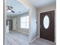 Inviting entryway featuring stylish wood-look floors and a view into the modern kitchen with stainless appliances at 1181 Mannbrook Dr, Stone Mountain, GA 30083