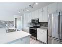 Updated kitchen featuring stainless steel appliances, modern countertops, and sleek backsplash at 1181 Mannbrook Dr, Stone Mountain, GA 30083