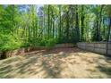 Large fenced backyard with a sprawling lawn and mature trees creates a private outdoor space at 1907 Shalimar Ne Dr, Atlanta, GA 30345