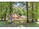 Exterior view of the home surrounded by mature trees at 240 Wellington Dr, Mcdonough, GA 30252