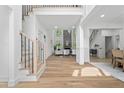 Open-concept living room with wood floors, high ceilings, modern staircase, and stylish decor at 1749 Patriots Nw Way, Kennesaw, GA 30152
