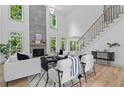 Bright living room boasts modern decor, a fireplace, and soaring ceilings with lots of natural light at 1749 Patriots Nw Way, Kennesaw, GA 30152