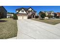 Two-story brick home features a two-car garage, landscaped yard, and a long concrete driveway at 2030 Hydrangea Ln, Austell, GA 30106