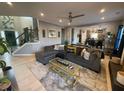Spacious living room features a comfortable sofa, modern ceiling fan, and an open view to the kitchen at 2030 Hydrangea Ln, Austell, GA 30106