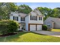 Charming two-story home with a well-manicured lawn and a two-car garage at 2332 Leacroft Way, Marietta, GA 30062