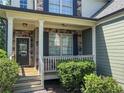 Inviting front porch with stone accents, wooden decking, and a charming railing, perfect for enjoying the outdoors at 251 Shaw Dr, Acworth, GA 30102