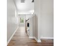 Bright hallway featuring laminate flooring, neutral walls, and a staircase leading to the upper level of the home at 251 Shaw Dr, Acworth, GA 30102