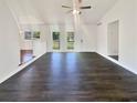 Spacious, light-filled living room with sleek dark wood flooring and neutral paint at 294 Farm Ridge Ne Dr, Woodstock, GA 30188