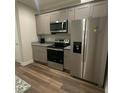 Updated kitchen featuring stainless steel appliances and grey cabinetry at 3407 Hidden Stream Ct, Stockbridge, GA 30281
