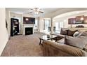Comfortable living room with a fireplace, large TV, and seamless flow into the dining area and kitchen at 517 Dasheill Ln, Atlanta, GA 30349