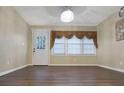Bright living room with hardwood floors, a modern chandelier, and natural light from large windows at 1083 Grace Dr, Forest Park, GA 30297