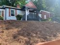 Charming home featuring a lovely covered porch and nicely landscaped yard with mature trees at 1298 Gideons Sw Dr, Atlanta, GA 30314