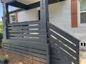 Charming front porch with gray painted wood and dark accents on a beautifully renovated home at 1298 Gideons Sw Dr, Atlanta, GA 30314