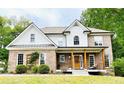 Beautiful two-story home with brick facade, white siding, and a cozy front porch at 2870 Willow Wisp Way, Cumming, GA 30040