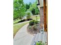 Landscaped front yard and a winding walkway leading to the house, surrounded by lush greenery at 2870 Willow Wisp Way, Cumming, GA 30040
