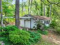 Detached one car garage, surrounded by mature trees and lush greenery at 3844 Lake Se Dr, Smyrna, GA 30082