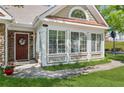 Charming front exterior showcasing a welcoming entrance with lush landscaping and plenty of natural light at 6103 Menlow Ct, Cumming, GA 30041