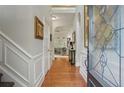 Inviting entryway with hardwood floors, decorative molding, and view into the living room at 104 Glentown Way, Sandy Springs, GA 30328