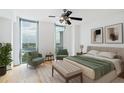 Bright bedroom with a ceiling fan, two chairs and green color accents and great natural light at 2870 Pharr Court South Nw # 1704, Atlanta, GA 30305