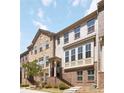 Attractive townhome displays a brick facade, large windows, and a welcoming entrance with landscaped surroundings at 371 Northaven Ave, Suwanee, GA 30024