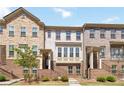 Charming brick townhome featuring multiple levels, classic architecture, and well-maintained landscaping at 371 Northaven Ave, Suwanee, GA 30024
