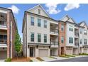 Charming two-story townhome with a brick and white painted brick facade and private garage at 427 Burton Dr, Alpharetta, GA 30009