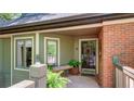 Charming front entrance with a cozy bench, lush plants and a decorative front door at 470 Ansley Walk Ne Ter, Atlanta, GA 30309