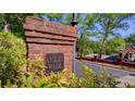 Ansley Walk brick neighborhood sign with mature trees and lush greenery at 470 Ansley Walk Ne Ter, Atlanta, GA 30309
