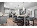 Modern kitchen featuring stainless steel appliances, granite countertops, and a large island with seating at 7554 Crawford Ct, Fairburn, GA 30213