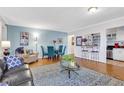 Open living room featuring stylish seating, wood floors, and a modern, bright kitchen at 300 Peachtree Ne St # 22N, Atlanta, GA 30308