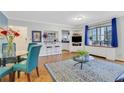 Comfortable living room with blue chairs, a glass table, and bright natural light at 300 Peachtree Ne St # 22N, Atlanta, GA 30308