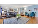 Spacious living room with black leather couch, wood floors, and blue accent pillows at 300 Peachtree Ne St # 22N, Atlanta, GA 30308