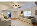 Spacious living area with shiplap walls, a large rug, and ample seating, creating a comfortable and welcoming atmosphere at 4265 Hurt Bridge Rd, Cumming, GA 30028